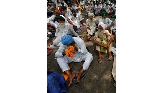Farmer attend a protest demanding complete debt waiver and good rates for their crops in New Delhi yesterday.