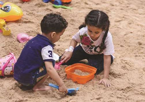 Children building sand castles at the Summer Entertainment City.