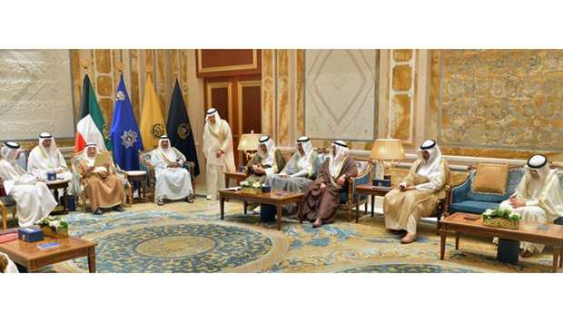 Sheikh Sabah al-Ahmad al-Jaber al-Sabah (3rd-L), Emir of Kuwait, reading a message received from His Highness the Emir Sheikh Tamim bin Hamad al-Thani after it was delivered by Qatari Foreign Minister Sheikh Mohammad Bin Abdulrahman al-Thani (L), at Bayan palace in Kuwait City.