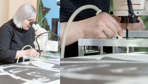 Conservator Friederike Steckling removes blemishes from a Warhol with a special sucking tool.
