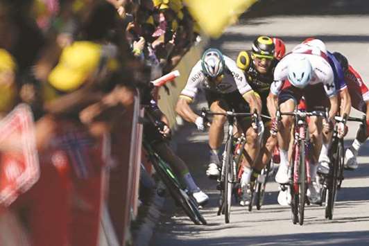 Slovakiau2019s Peter Sagan (second from left) sends Great Britainu2019s Mark Cavendish crashing with an elbow near the finish line of the fourth stage of the Tour de France in Vittel, France, yesterday. (AFP)