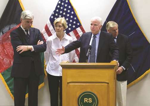 US Senator John McCain (centre) speaks at a press conference at Resolute Support headquarters in Kabul yesterday, next to US Senators Lindsey Graham (right), Elizabeth Warren (2nd left) and Sheldon Whitehouse (left).