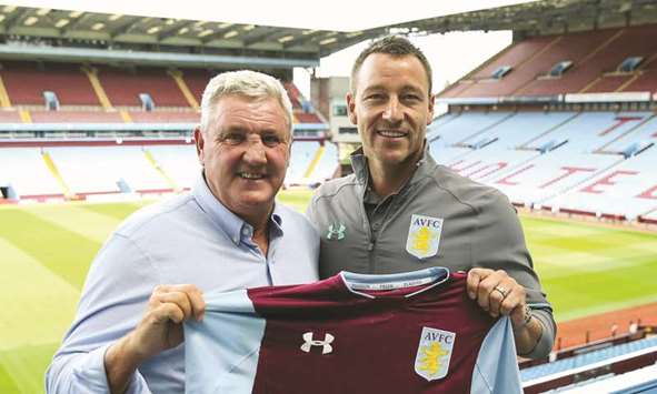 John Terry (right) is unveiled at Aston Villa on Monday alongside manager Steve Bruce, who believes his new signing is u2018worth every pennyu2019 of his reported u00a360,000-per-week contract and can bring them back to the top flight status.
