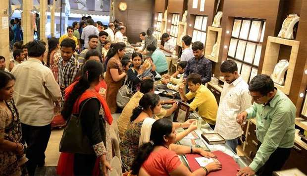 Indian customers gather to purchase gold items in a jewellery shop