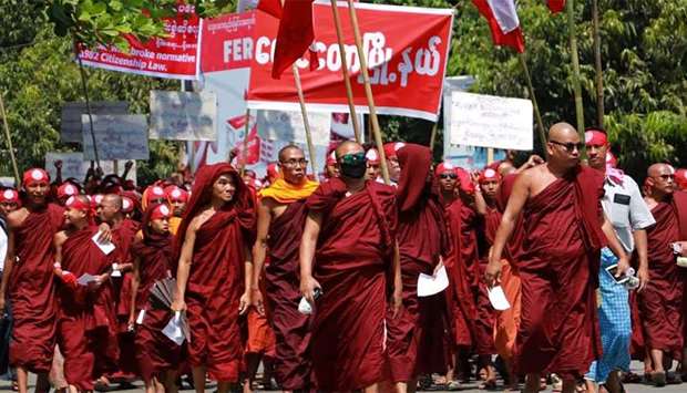 Monks and ethnic Rakhine protesters take part in a demonstration in Sittwe township, Rakhine state