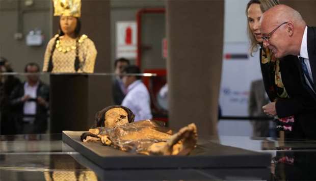 Peru's Foreign Commerce and Tourism Minister Eduardo Ferreyros looks at the replica of The Lady of Cao at the Ministry of Culture in Lima