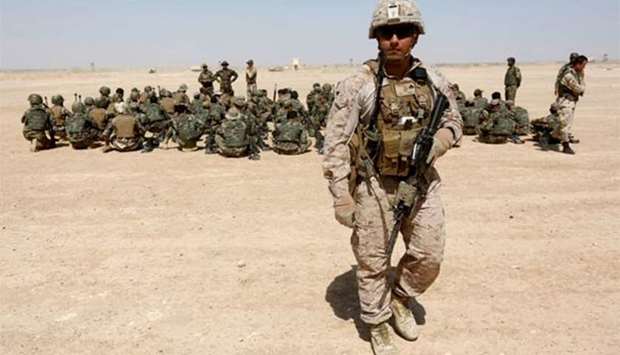 A US Marine walks near Afghan National Army soldiers during training in Helmand province on Wednesday.