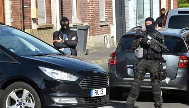 Police officers patrol a street on Wattignies, northern France, after a man was arrested during a French-Belgian anti-terrorist operation on Wednesday.