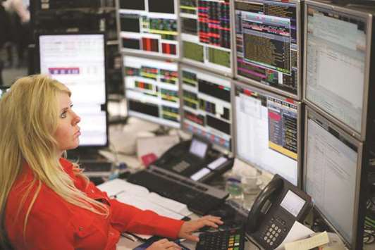 A trader is seen at the London Stock Exchange. The FTSE 100 rose 0.1% to 7,367.60 points yesterday.