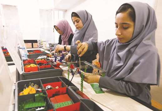 Members of Afghan robotics girls team which was denied entry into the United States for a competition, work on their robots in Herat province, Afghanistan, on July 4, 2017.