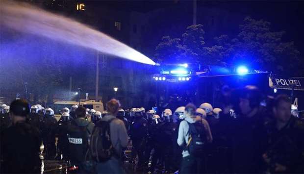 German riot police use a water cannon during a protest ahead the G20 summit in Hamburg