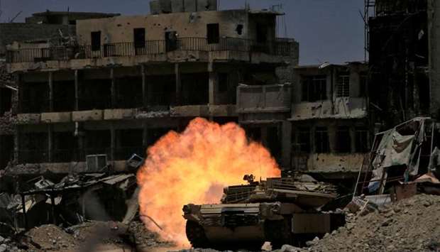 A tank of the Emergency Response Division fires at Islamic State militant in Mosul