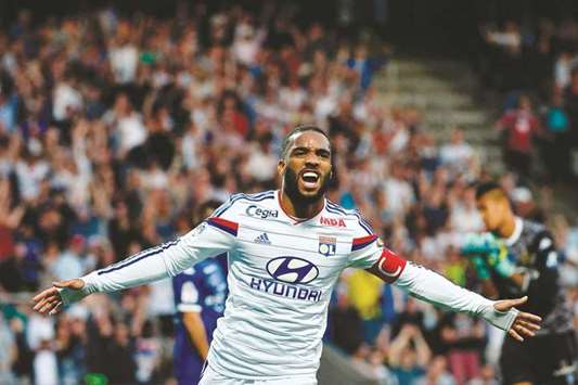 This file photo shows Lyonu2019s French forward Alexandre Lacazette celebrating after scoring a goal during the French L1 football match against SC Bastia (SCB).
