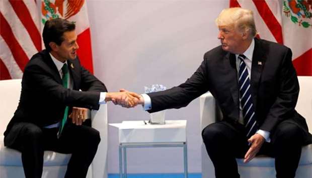 US President Donald Trump shakes hands with Mexico's President Enrique Pena Nieto during the their bilateral meeting at the G20 summit in Hamburg on Friday.