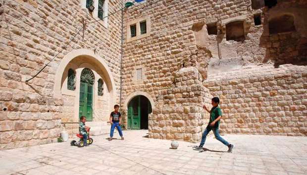 Palestinian children play with a ball outside their house in the old town of the West Bank city of Hebron.