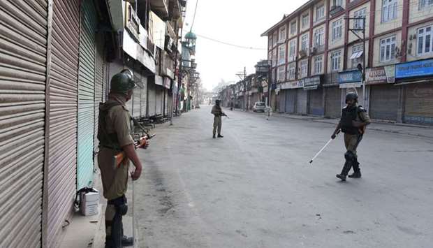 Indian paramilitary troopers patrol during a curfew in Srinagar