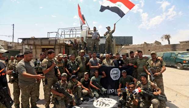 Members of the Emergency Response Division celebrate in the Old City of Mosul