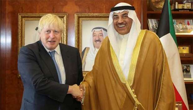 Kuwaiti Foreign Minister Sheikh Sabah al-Khaled al-Sabah shaking hands with his British counterpart Boris Johnson in Kuwait City on Saturday.