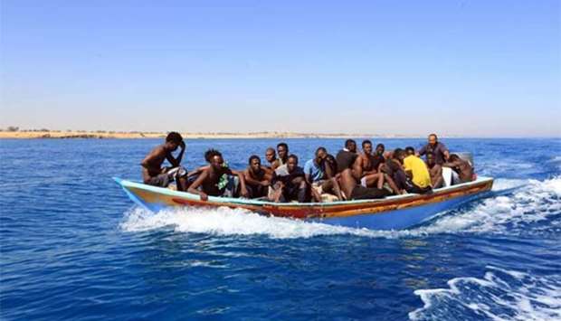 Libyan coastguards help rescue illegal immigrants attempting to reach Europe off the coastal town of Guarabouli on Saturday.