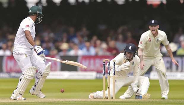 South Africau2019s Vernon Philander (left) is bowled by Englandu2019s Moeen Ali (unseen) as wicket-keeper Jonny Bairstow and Ben Stokes (right) look on during the third day of the first Test match at Lordu2019s Cricket Ground in central London, yesterday. (AFP)