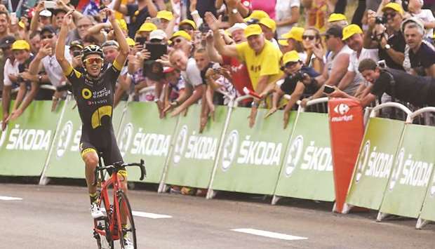 Franceu2019s Lilian Calmejane celebrates as he crosses the finish line at the end of the 187.5km eighth stage of the 104th edition of the Tour de France between Dole and Station des Rousses yesterday. (AFP)