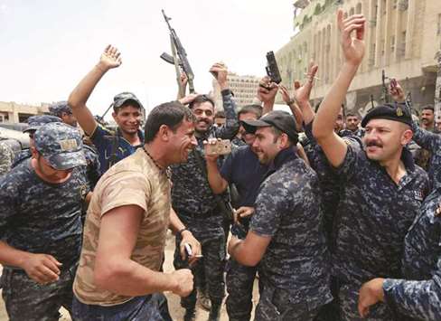 Iraqi Federal police celebrate in the Old City of Mosul, yesterday.