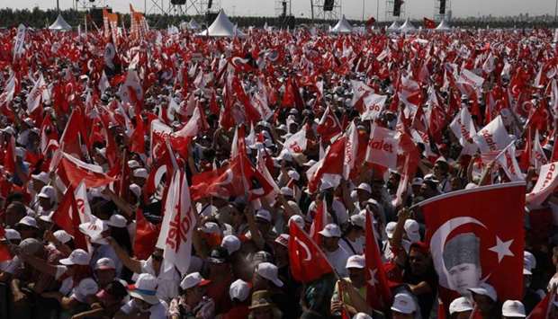 People wave Turkish flags during a rally to mark the end of the main opposition Republican People's Party (CHP) leader Kemal Kilicdaroglu's 25-day long protest, dubbed ,Justice March,, against the detention of the party's lawmaker Enis Berberoglu, in Istanbul.