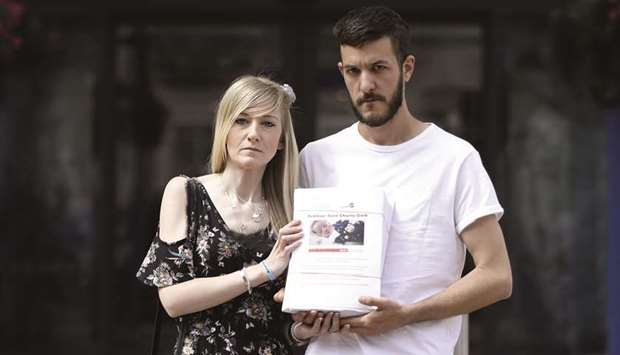 Connie Yates and Chris Gard, parents of terminally-ill Charlie Gard, pose with a petition of signatures supporting their case, prior to delivering it to the Great Ormond Street Hospital for Children in central London yesterday.