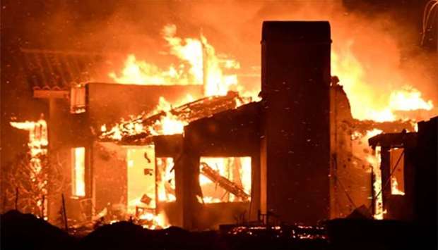 A house burns as firefighters battle a fast-moving wildfire that destroyed homes in Goleta, California, on the weekend.