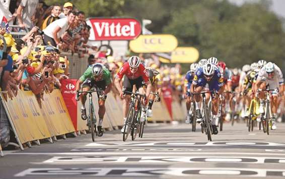 Fernando Gaviria (right) crosses the finish line first on stage four of the Tour de France ahead of Peter Sagan (left) and Andru00e9 Greipel (centre) yesterday. (Reuters)