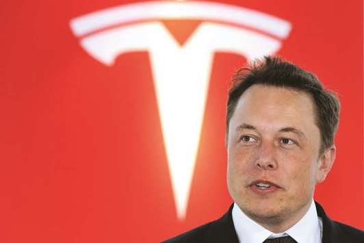 Elon Musk, co-founder and chief executive officer of Tesla Motors attends a key delivery ceremony of the companyu2019s premium electric sedan Model S vehicles to customers in Tokyo (file). Musk had previously criticised Chinau2019s tough auto rules for foreign businesses, which would have required it to cede a 50% share in the factory.
