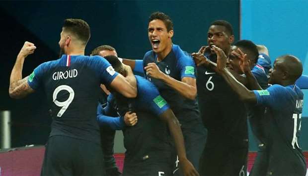 France's Samuel Umtiti celebrates with team mates after scoring their first goal