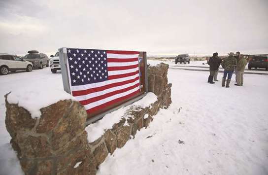 A US flag covers a sign at the entrance of the Malheur National Wildlife Refuge near Burns, Oregon, in this January 3, 2018 file photo.