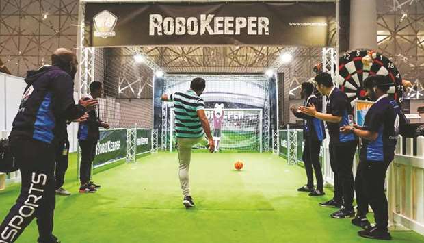 A robo keeper tests an enthusiastu2019s football skills.