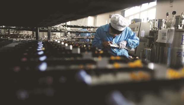 A labourer works inside an electronics factory in Qingdao, Shandong province. Chinau2019s official Purchasing Managersu2019 Index  released yesterday fell to 51.5 in June, below analystsu2019 forecast of 51.6 and down from 51.9 in May, but it remained well above the 50-point mark that separates growth from contraction for a 23rd straight month.