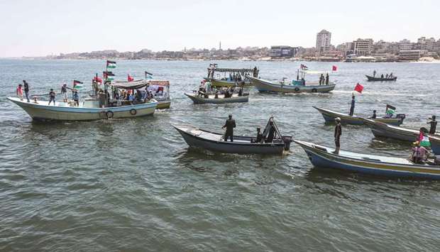 Activists escort a blockade-running boat carrying Palestinian students and others injured during protests out to sea from the Gaza City harbour yesterday against Israelu2019s naval blockade on the Gaza Strip.