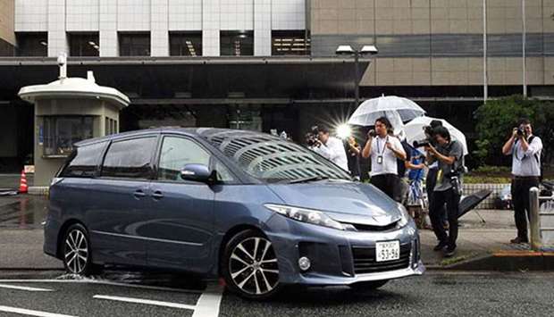 The nurse, leaving in a police car, has told police she may have killed up to 20 people. Picture: Asahi Shimbun