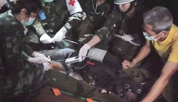 A video grab taken from footage released by the Royal Thai Navy shows a member of the ,Wild Boars, Thai youth football team being moved on a stretcher during the rescue operation inside the Tham Luang cave.