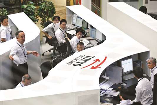 Employees work at the Tokyo Stock Exchange (file). The Nikkei 225 closed down 1.2% to 21,932.21 points yesterday.