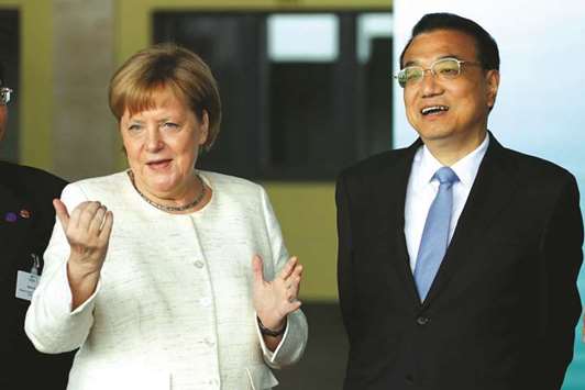 German Chancellor Angela Merkel and Chinese Prime Minister Li Keqiang arrive at a presentation for autonomous driving at Tempelhof airport in Berlin.  Germanyu2019s BASF managed to wrap up a preliminary deal to build Chinau2019s first wholly foreign-owned chemicals complex quite quickly, aided in part by trade tensions between China and the US, sources with knowledge of the matter said.