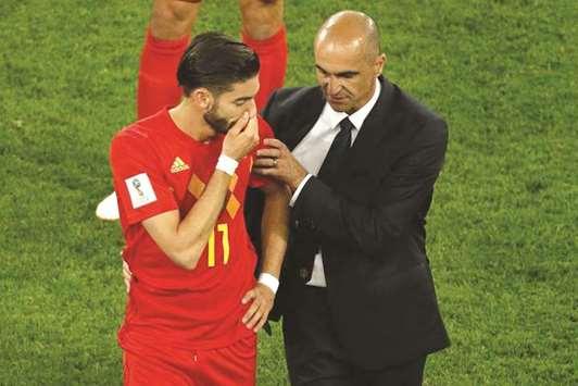 Belgiumu2019s midfielder Yannick Ferreira-Carrasco (left) is consoled by Belgiumu2019s coach Roberto Martinez at the end of the Russia 2018 World Cup semi-final against France at the Saint Petersburg Stadium in Saint Petersburg.  (AFP)