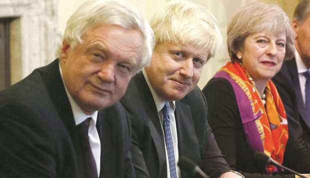 In this file photo taken on November 28, 2016, British Prime Minister Theresa May (R) sits with members of her cabinet British Secretary of State for Exiting the European Union (Brexit Minister) David Davis (L) and British Foreign Secretary Boris Johnson in the Cabinet Room inside 10 Downing Street in central London. British Foreign Secretary Boris Johnson has resigned, Downing Street said in a statement on July 9, 2018, hours after Brexit minister David Davis stepped down.