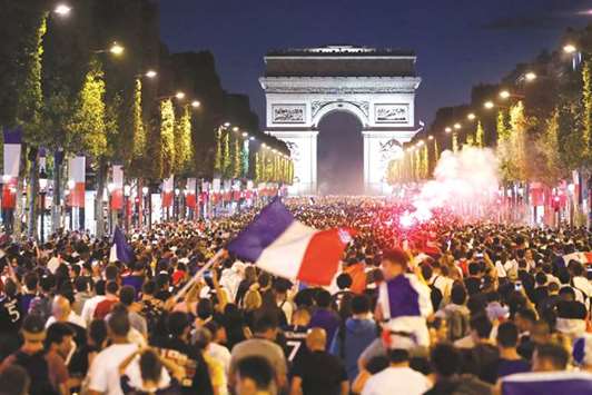 France fans celebrate the FIFA World Cup semi-final victory over Belgium on the Champs Elysees in Paris on Tuesday. (Reuters)