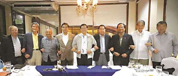 A group of retired senior officers from the Armed Forces of the Philippines and the Philippine National Police, which formed themselves into an advocacy group that promotes and increases awareness of national interests, link arms during a press conference at the Club Filipino in San Juan City, yesterday.