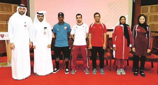Qataru2019s shooters Reem al-Sharshani, Matara al-Aseiri and Ahmed Mohsen al-Ali, boxer Abdullatif Mohamed Sadiq and footballer Hatem Kamal pose with the QOC officials yesterday.