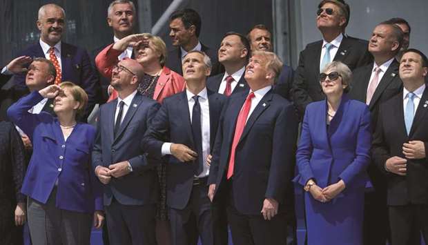 (Front row, from left) German Chancellor Angela Merkel, Belgiumu2019s Prime Minister Charles Michel, Nato Secretary-General Jens Stoltenberg, US President Donald Trump, Britainu2019s Prime Minister Theresa May, Estoniau2019s Prime Minister Juri Ratas and other Nato heads of state watch a helicopter flyover after a family photo for the Nato summit in Brussels yesterday.