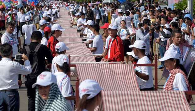 Cambodians roll out a 1,149.8 metre-long krama scarf so it can be declared as the world's longest hand woven scarf, in Phnom Penh