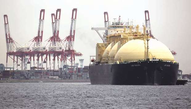 An LNG tanker sails past a container terminal as it arrives at Tokyo Gas Cou2019s Negishi LNG terminal in Yokohama, Japan, on May 21. To reduce emissions and provide affordable electricity, the world needs to burn more fossil fuels, not less. Thatu2019s the  message being delivered by the worldu2019s biggest energy companies at the World Gas Conference in Washington last week, where they championed natural gas as the fuel of the future, rather than one that simply bridges the gap toward renewables.