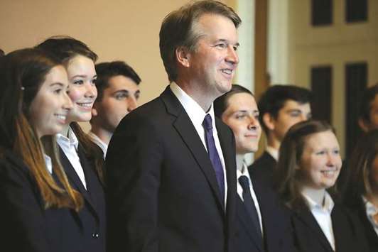 Judge Brett Kavanaugh stands with members of the Senate Page programme at the US Capitol yesterday.