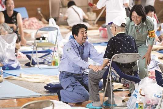 Japanu2019s Prime Minister Shinzo Abe visits a shelter for people affected by the recent flooding in Mabi, Okayama prefecture.
